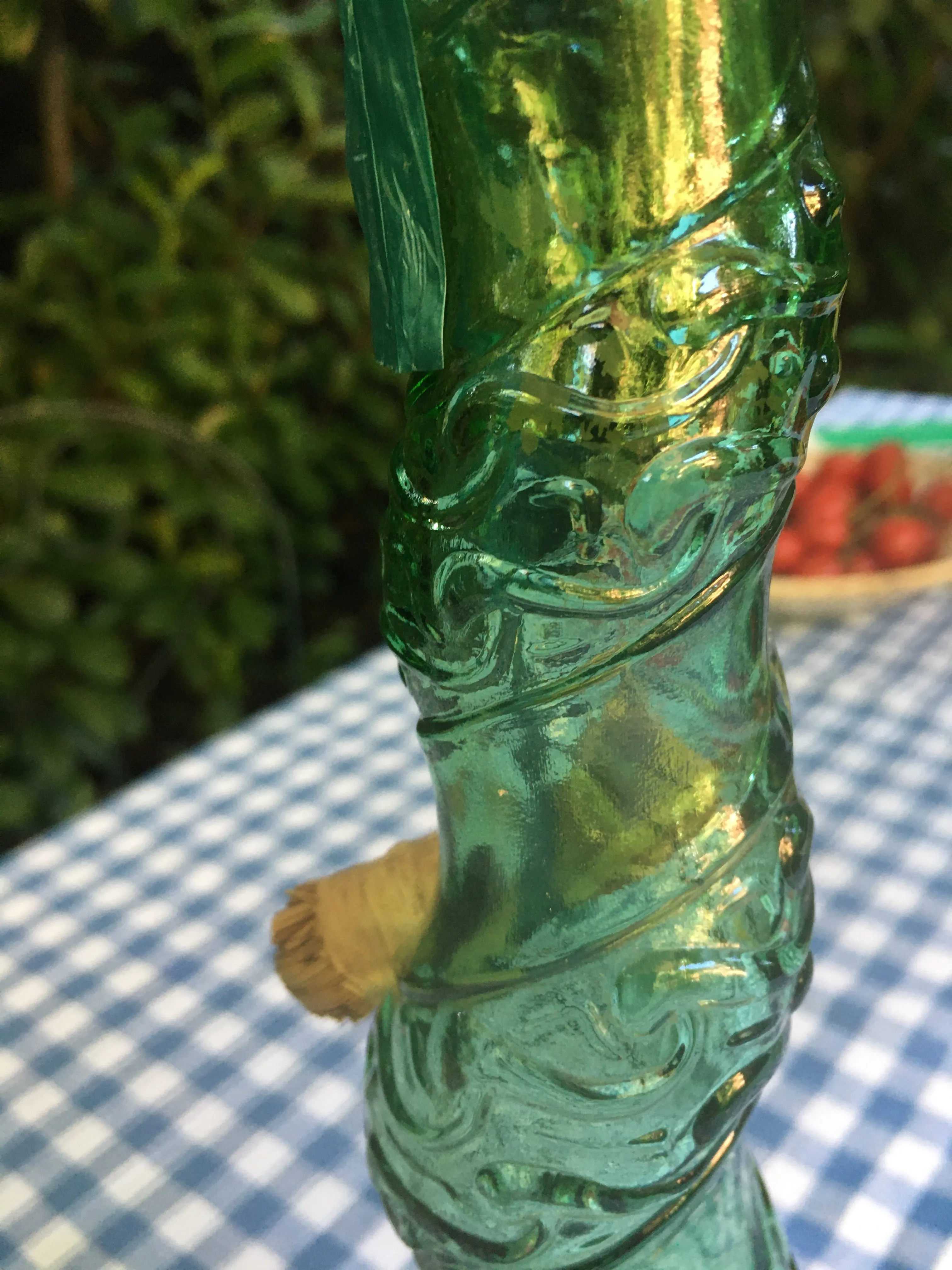 Large Vintage Emerald green Spiral glass decanter from Empoli, Italy. Spiral design with floral convolute embossing. Genie bottle